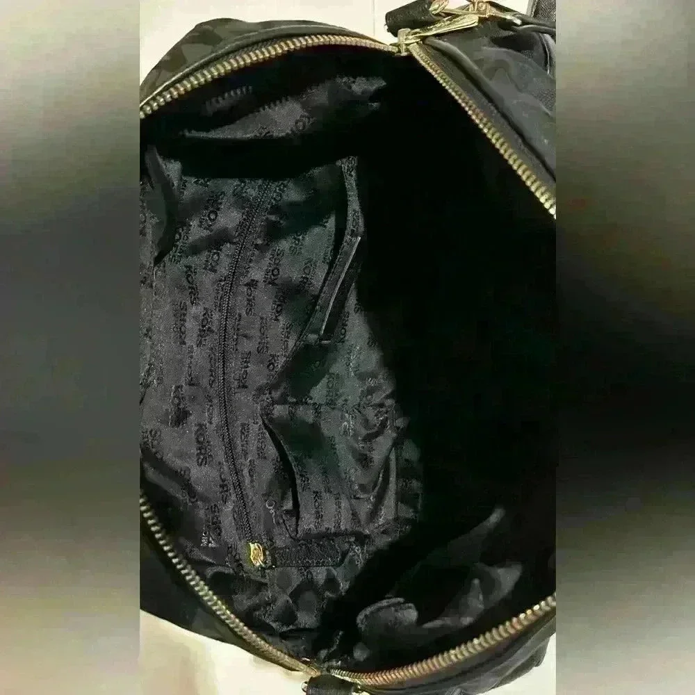 A Mickael Kors black Gladstone satchel with gold tone hardware.